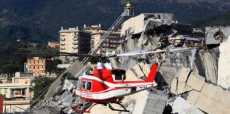 Rescuers search rubble for survivors after motorway bridge collapses in Genoa, Italy leaves at least 26 dead