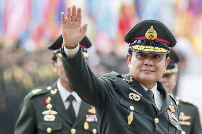 Thailand's Prime Minister Prayuth Chan-ocha waves after a handover ceremony for the new Royal Thai Army Chief at the Thai Army Headquarters in Bangkok