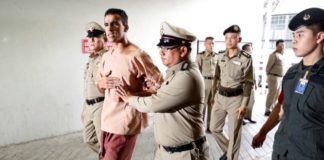Feet shackled, Bahraini footballer arrives at Thai court to fight extradition