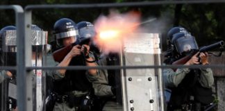 Police battle protesters as strike paralyses Hong Kong